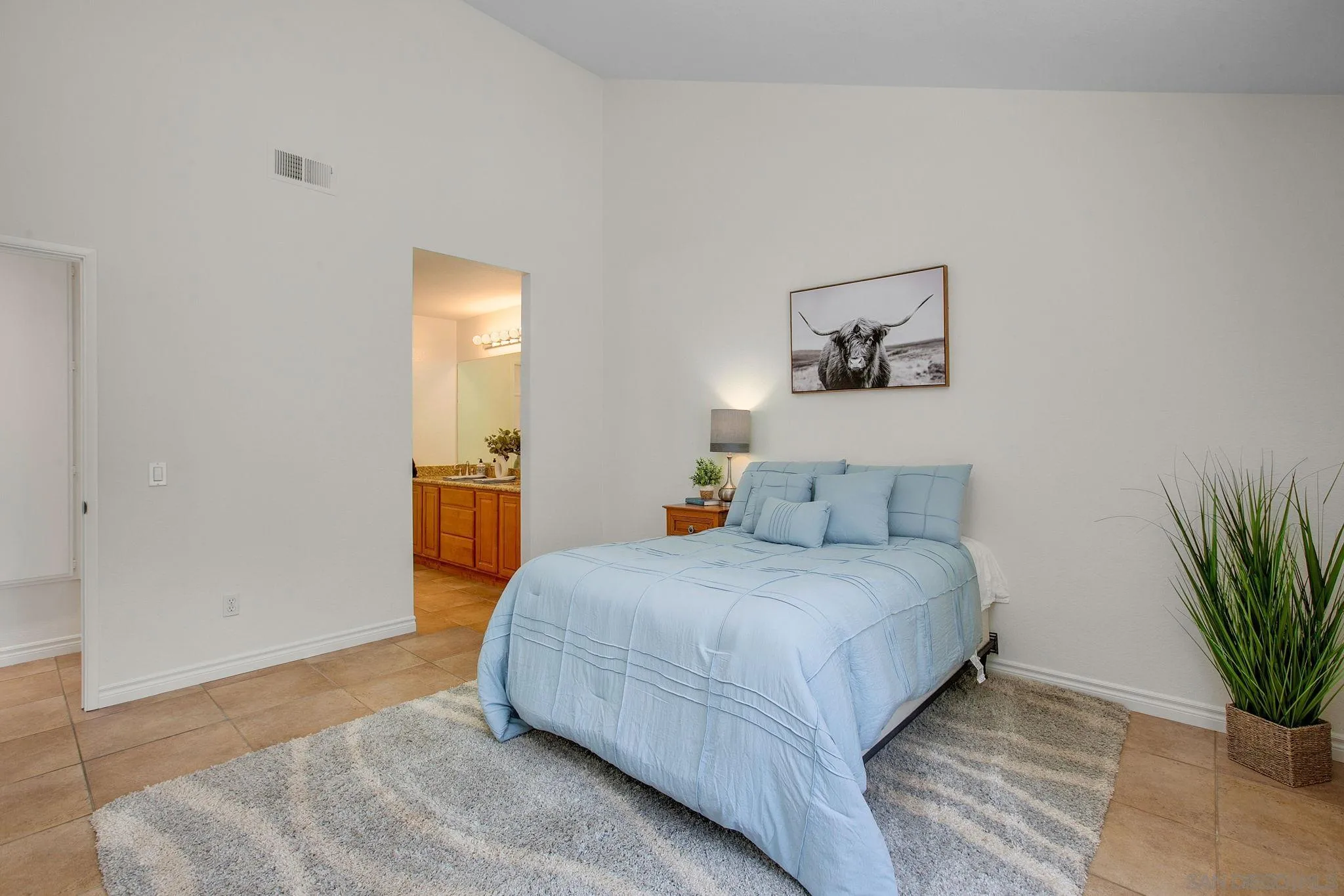 2041 Coolngreen Lane Encinitas, CA 92024 - Photo 20 of 36 a bedroom with a bed and a potted plant
