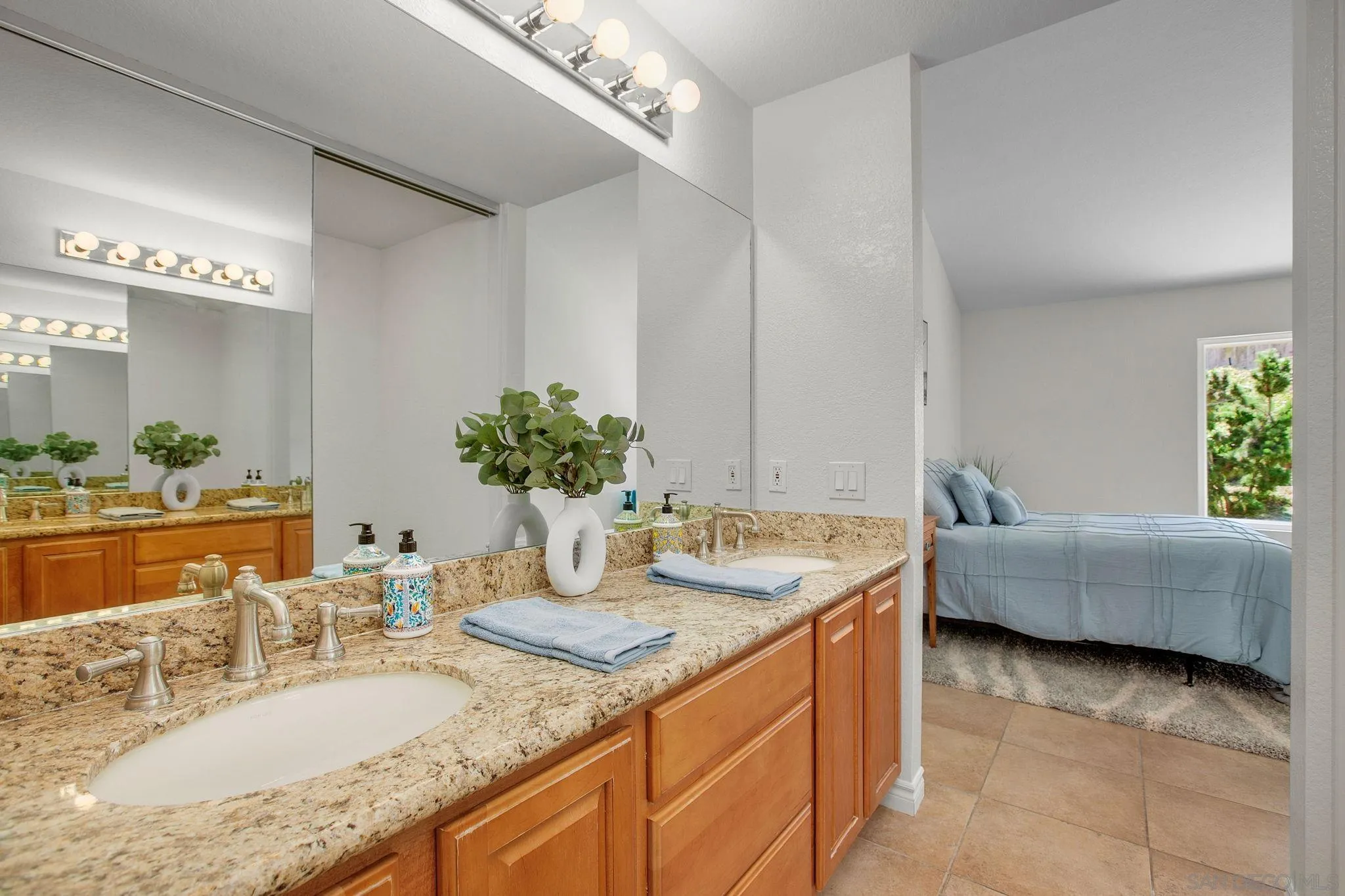 2041 Coolngreen Lane Encinitas, CA 92024 - Photo 22 of 36 a bathroom with a granite countertop sink a mirror and a bathtub