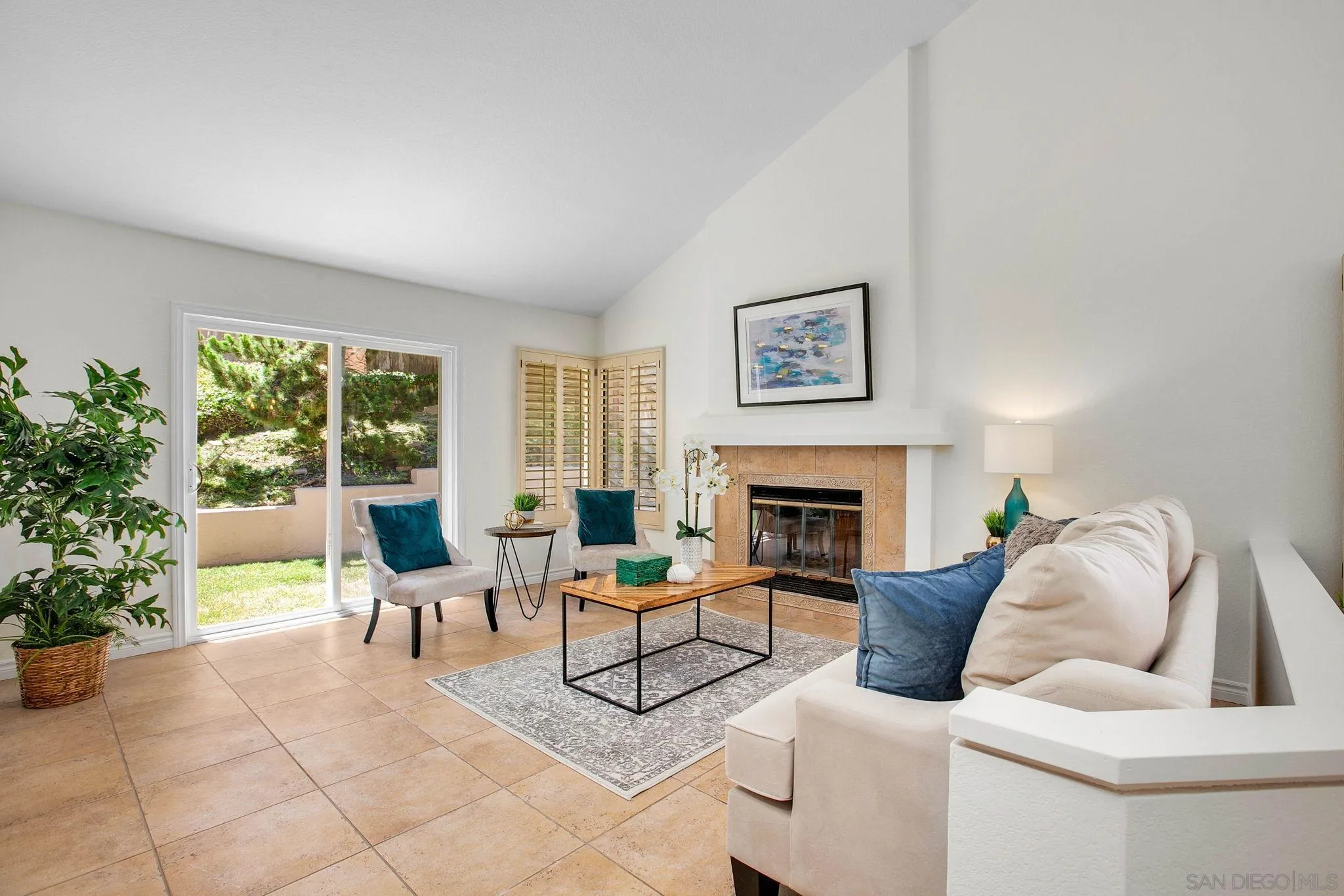 2041 Coolngreen Lane Encinitas, CA 92024 - Photo 10 of 36 a living room with furniture a fireplace and a potted plants