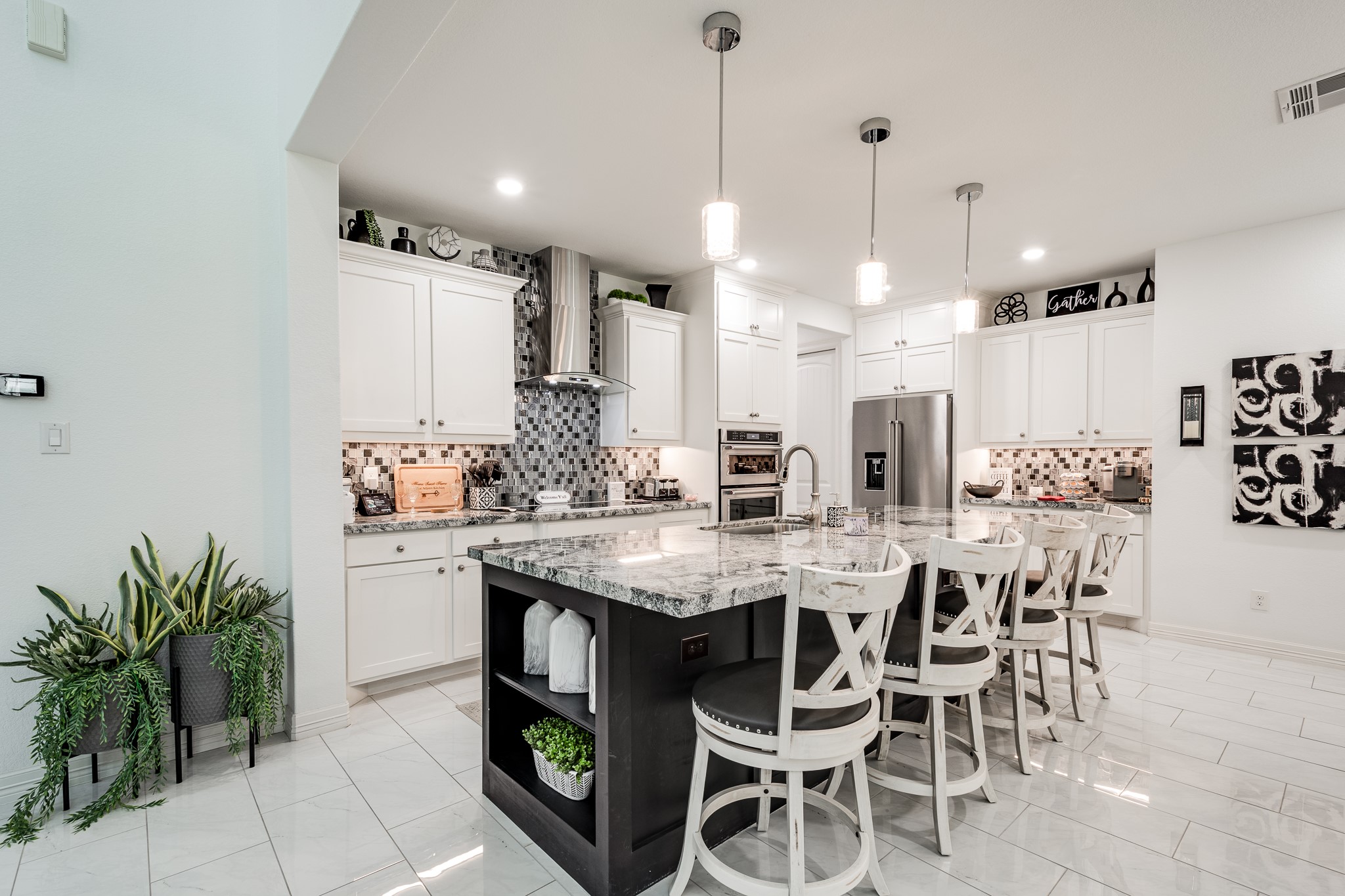 59 County Road Dayton, TX 77535 - Photo 18 of 50 a kitchen with stainless steel appliances kitchen island granite countertop a table chairs and white cabinets
