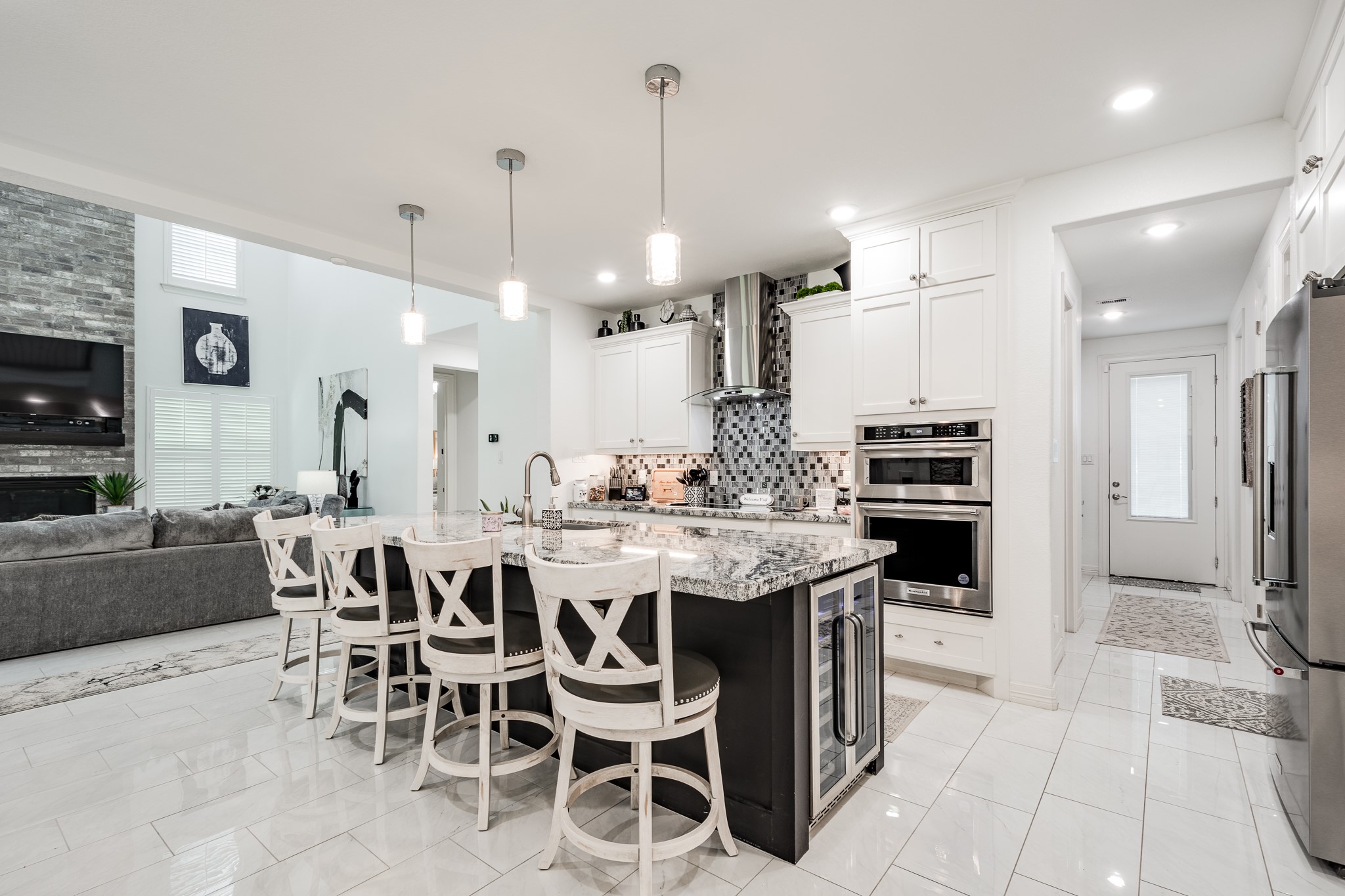 59 County Road Dayton, TX 77535 - Photo 19 of 50 a kitchen with stainless steel appliances kitchen island granite countertop a table chairs and a refrigerator