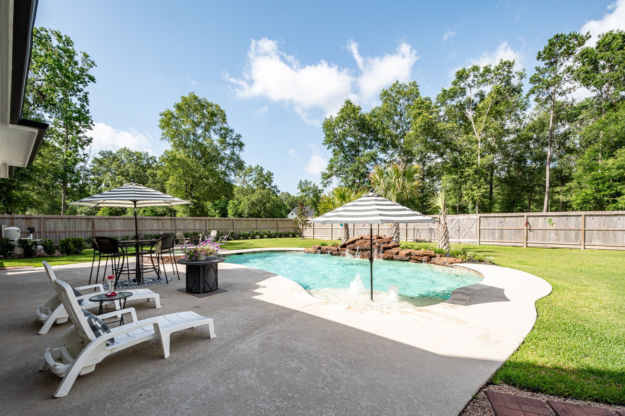 59 County Road Dayton, TX 77535 - Photo 37 of 50 a view of a patio with a table and chairs under an umbrella