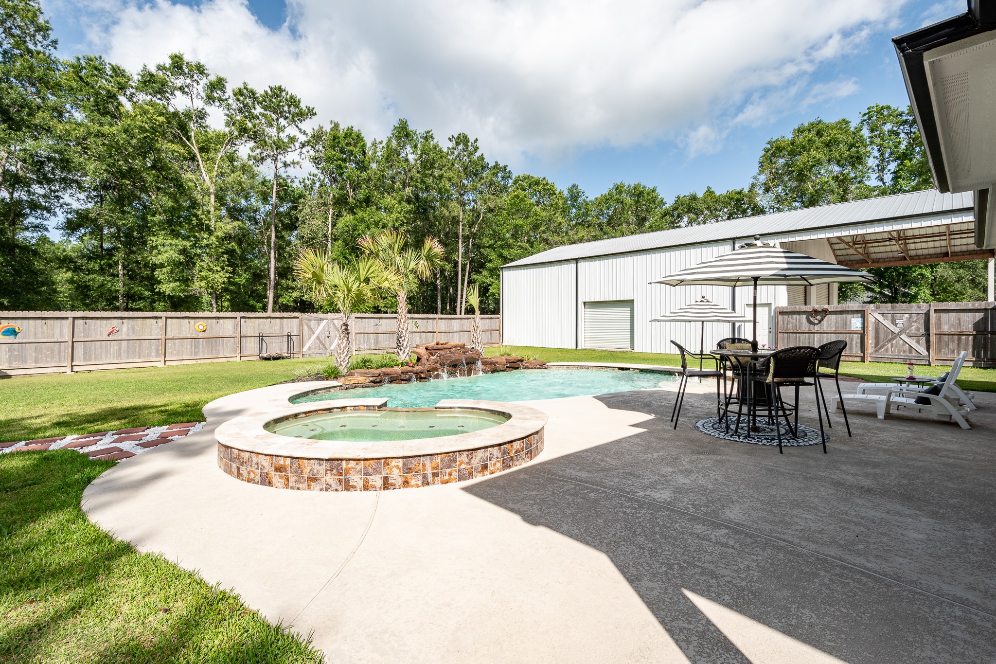 59 County Road Dayton, TX 77535 - Photo 39 of 50 a backyard of a house with yard and outdoor seating