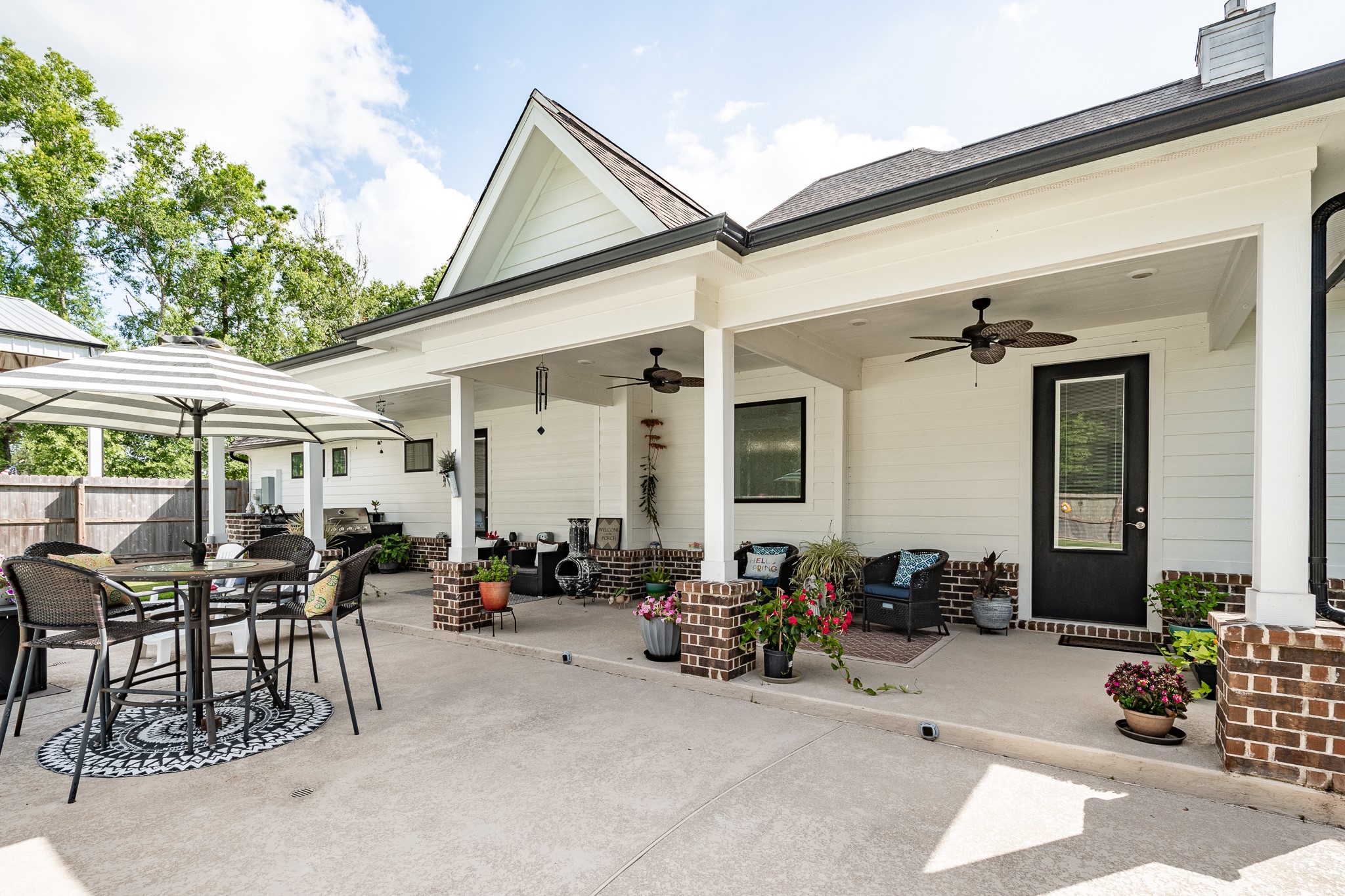 59 County Road Dayton, TX 77535 - Photo 45 of 50 a view of a patio with table and chairs under an umbrella