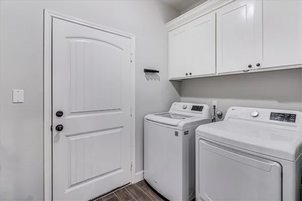 a view of a bedroom with wooden floor closet and window