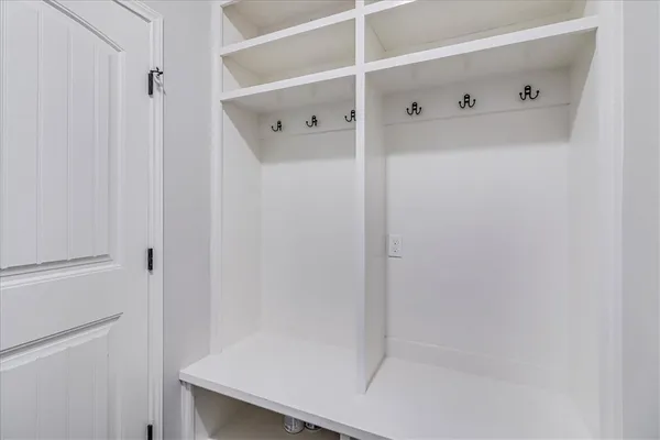 a bathroom with a granite countertop toilet sink and mirror