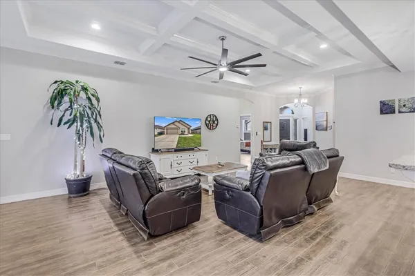 a living room with furniture and a wooden floor