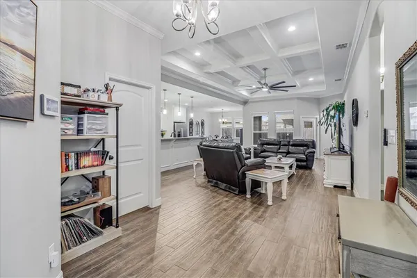a large white kitchen with lots of counter space a sink a window and stainless steel appliances