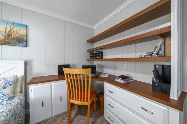 a storage room with wooden floor and cabinets