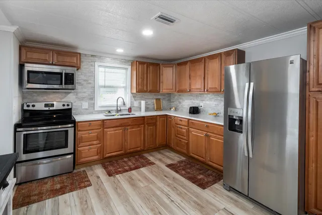 a kitchen with a refrigerator stove and sink