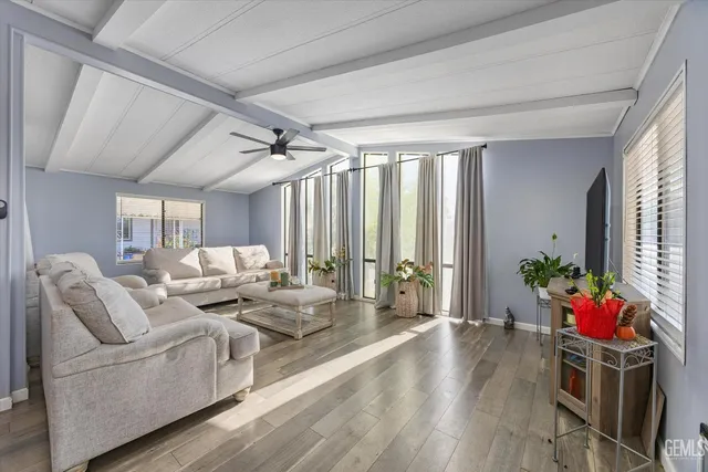 a living room with furniture and flowers