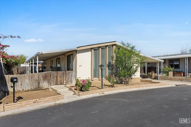 a front view of a house with basket ball court and a fire pit