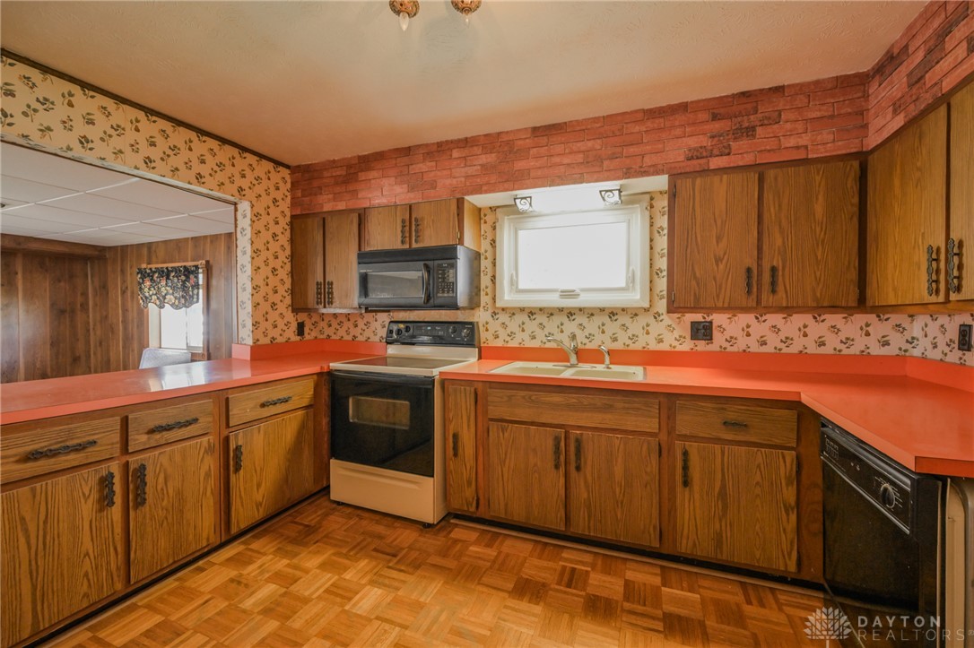 3057 Springfield Xenia Road Springfield, OH 45506 - Photo 13 of 37 This kitchen offers functional cabinetry, a convenient range, and durable flooring for daily living.