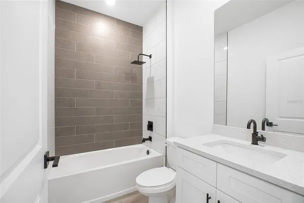 a bathroom with a sink a toilet and a bathtub