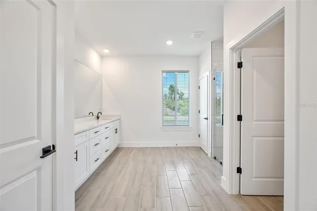 a view of a room with wooden floor and window
