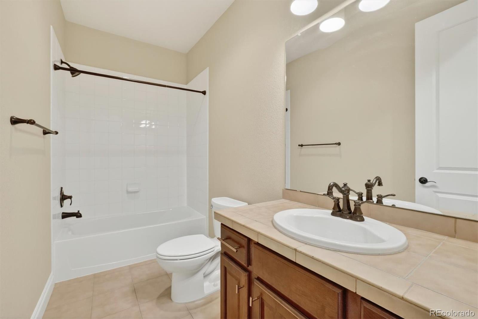 10126 RidgeGate Circle Lone Tree, CO 80124 - Photo 29 of 32 a bathroom with a sink toilet tub and shower