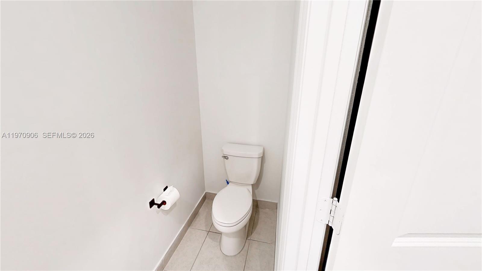 13158 Southwest 233rd Street Homestead, FL 33032 - Photo 18 of 72 a white toilet sitting next to a white cabinet
