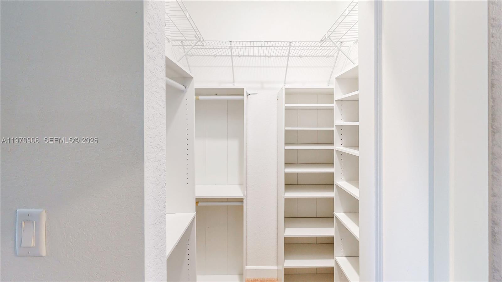 13158 Southwest 233rd Street Homestead, FL 33032 - Photo 24 of 72 a view of walk in closet with empty racks