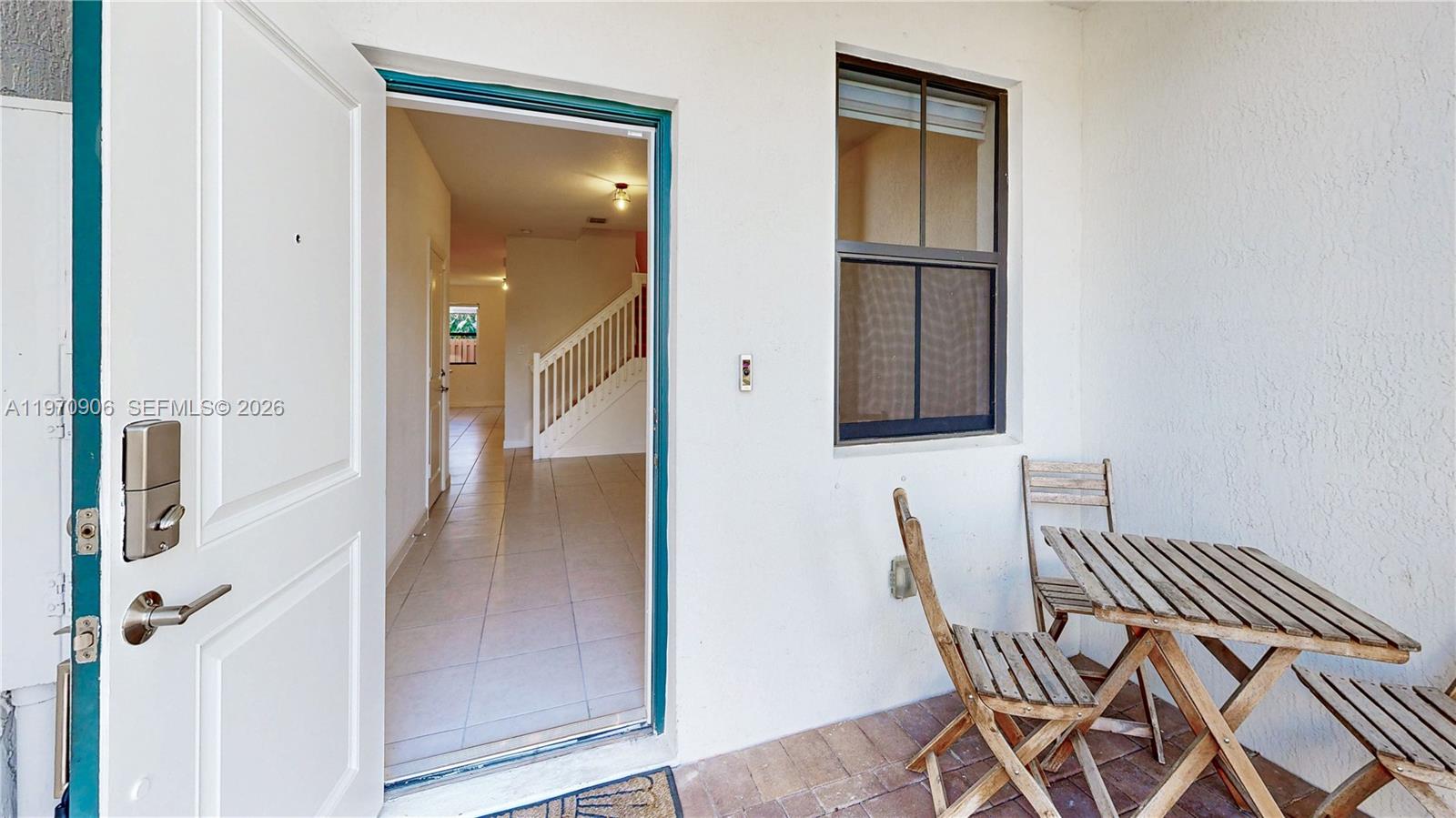 13158 Southwest 233rd Street Homestead, FL 33032 - Photo 3 of 72 a view of a hallway with furniture and wooden floor