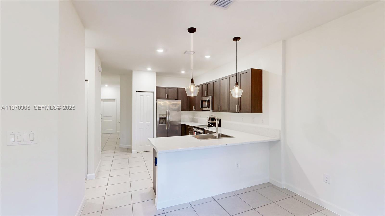 13158 Southwest 233rd Street Homestead, FL 33032 - Photo 10 of 72 a room with a sink a mirror and shower