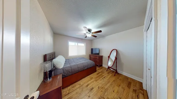 a bedroom with bed and a chandelier