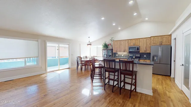 a view of a livingroom with furniture hardwood floor and windows