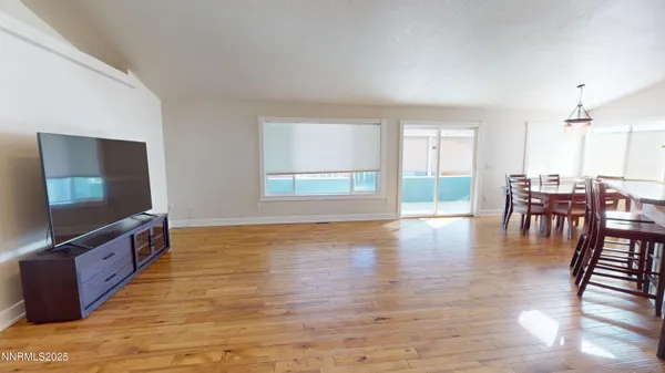 a view of dining room with furniture and wooden floor