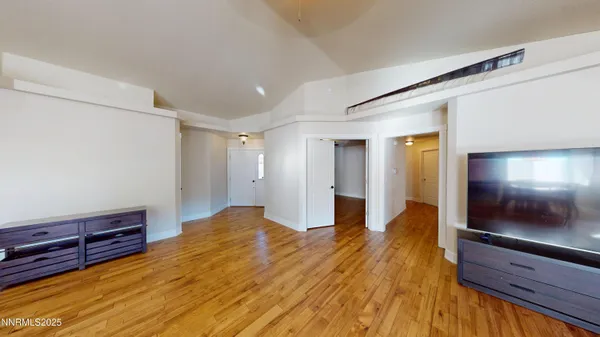 a view of a room with wooden floor and air conditioner