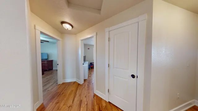 a view of a hallway with wooden floor