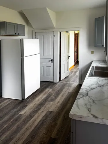 a kitchen with a refrigerator a stove and a sink