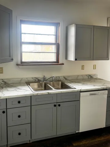a kitchen with a sink cabinets and window