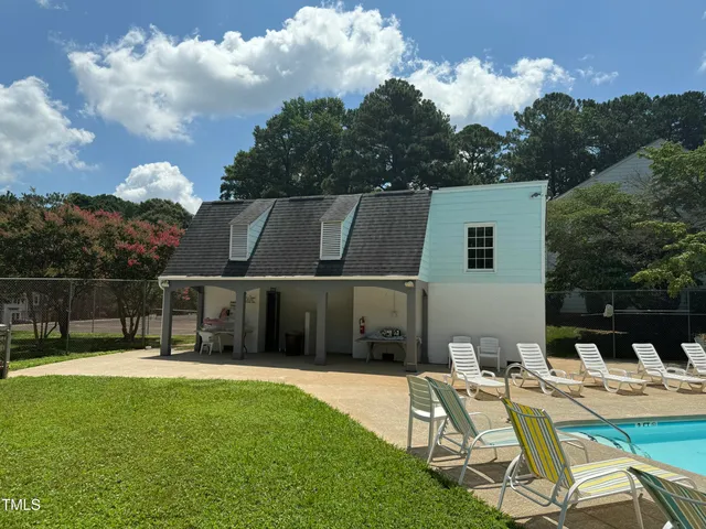 a view of a house with backyard porch and sitting area