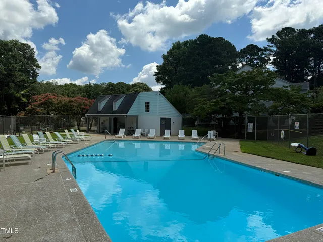 a view of house with swimming pool having outdoor seating