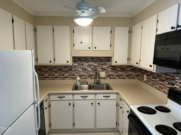 a kitchen with a stove a sink and a refrigerator