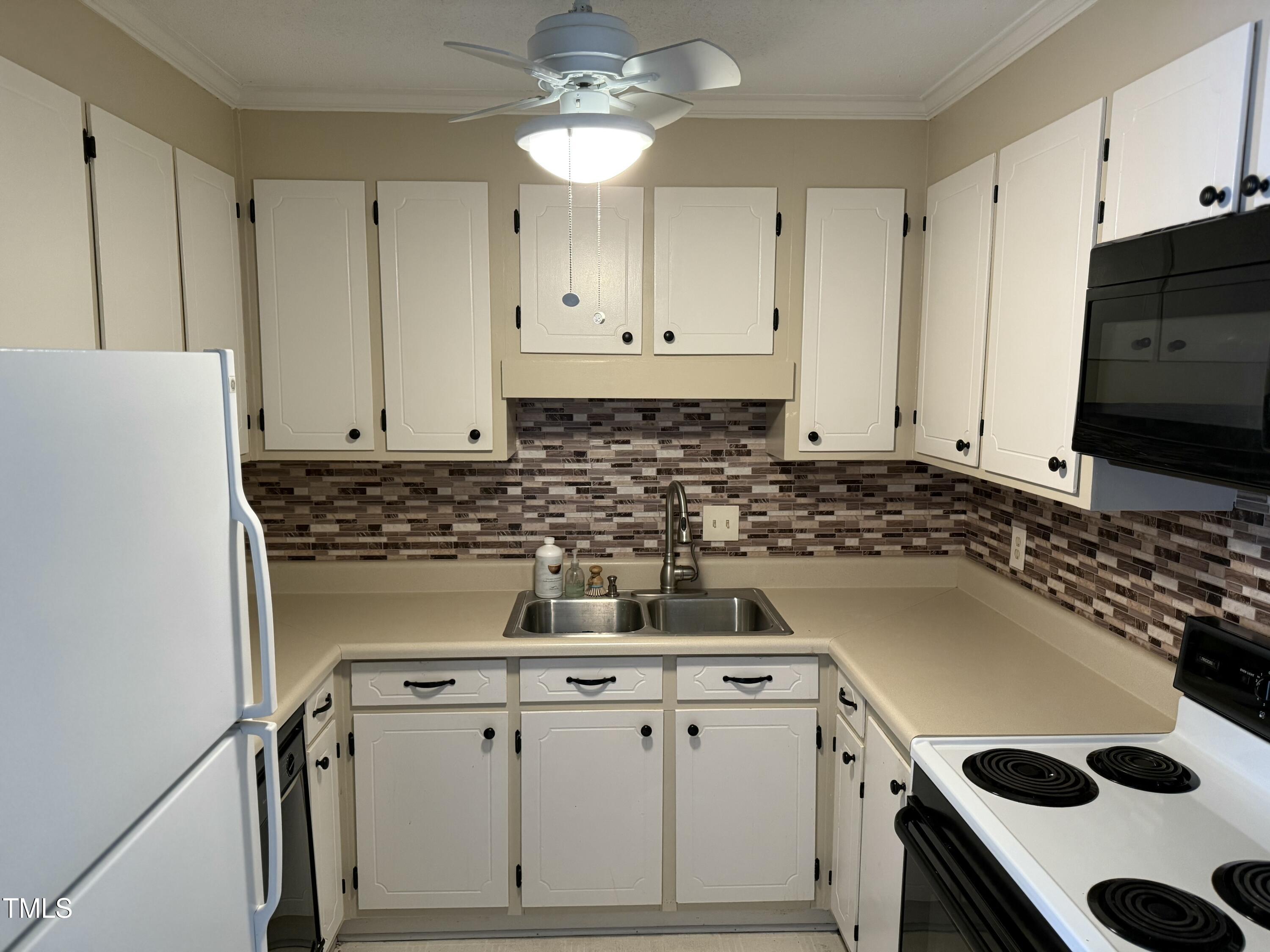 1344 Garden Crest Circle Raleigh, NC 27609 - Photo 6 of 6 a kitchen with a stove a sink and a refrigerator
