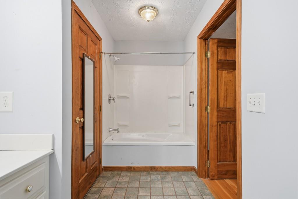 176 Big Oak Tree Road Northwest Adairsville, GA 30103 - Photo 32 of 77 a bathroom with a bathtub and a shower