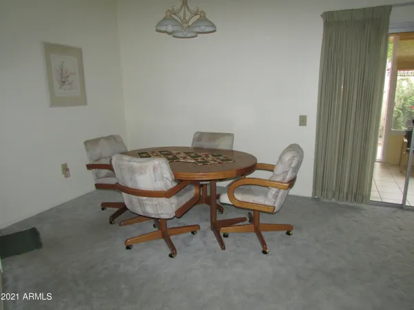 a view of a dining room with furniture and window