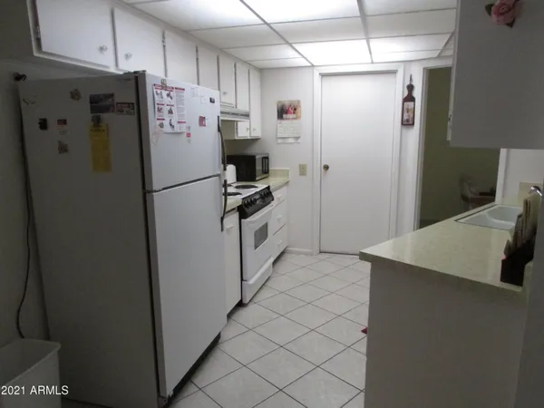 a white refrigerator freezer sitting in a kitchen