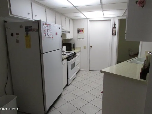 a white refrigerator freezer sitting in a kitchen