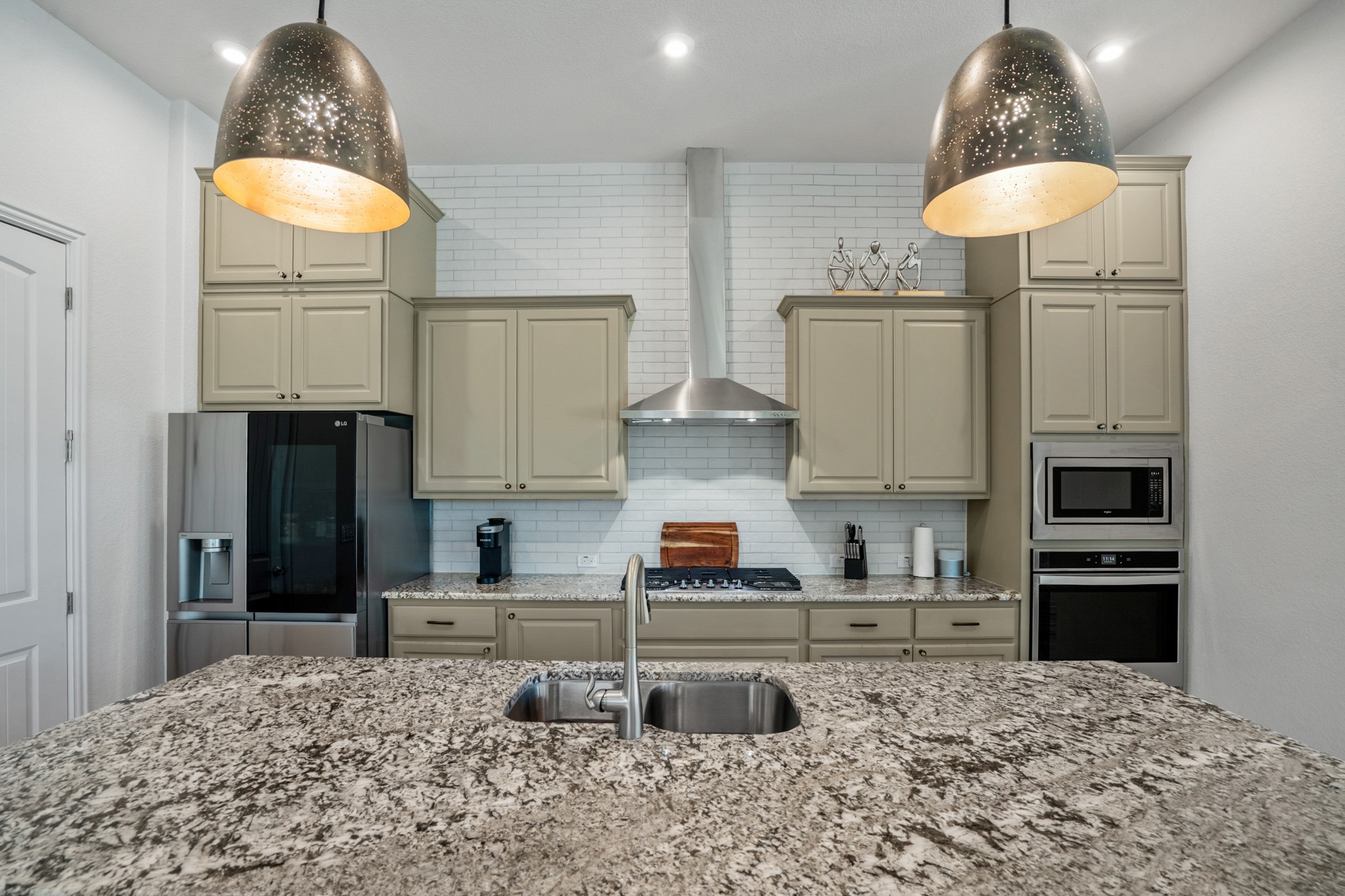224 Diamondback Drive Georgetown, TX 78628 - Photo 11 of 39 a kitchen with stainless steel appliances granite countertop a stove a refrigerator and a sink