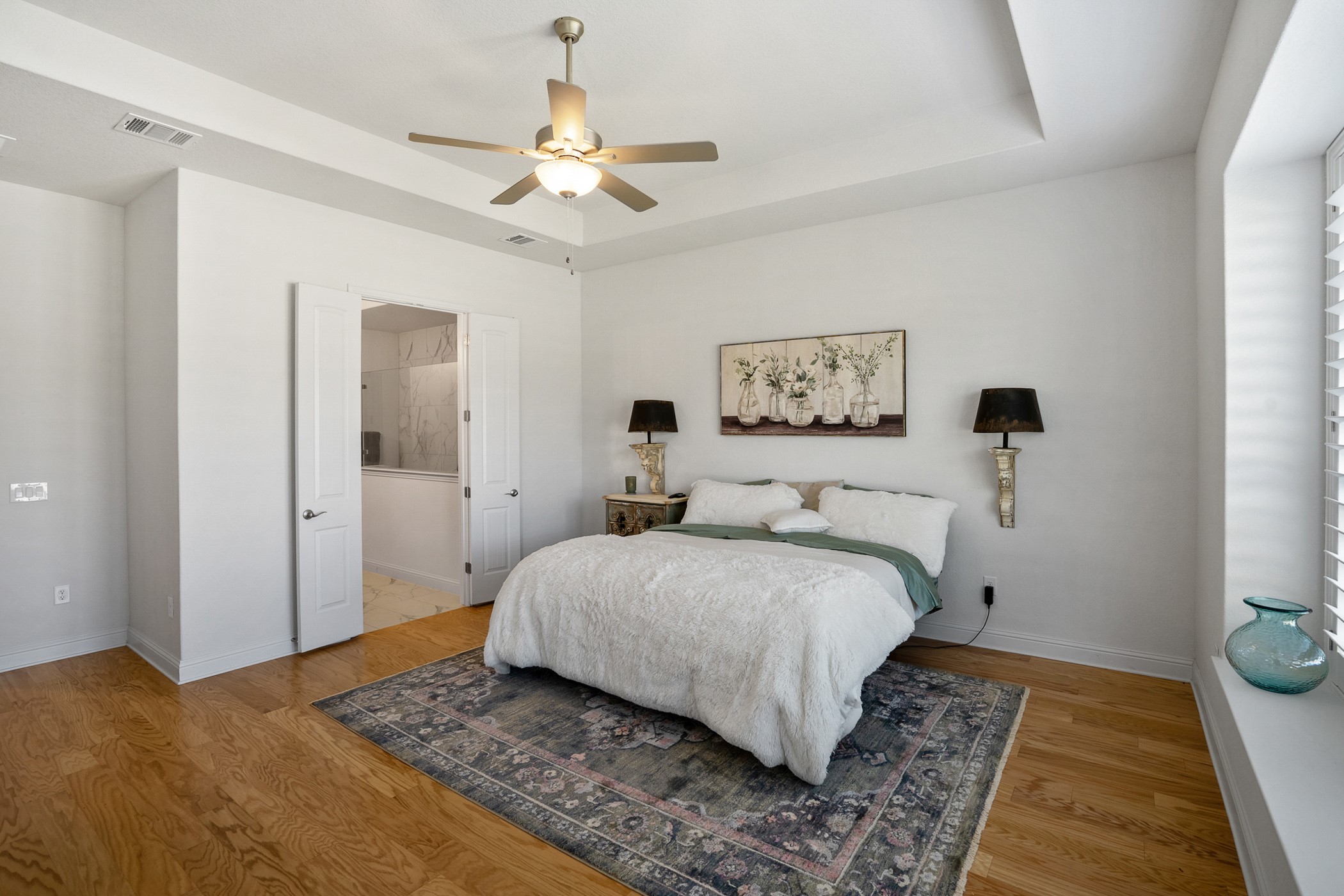 224 Diamondback Drive Georgetown, TX 78628 - Photo 25 of 39 a spacious bedroom with a bed and a chandelier