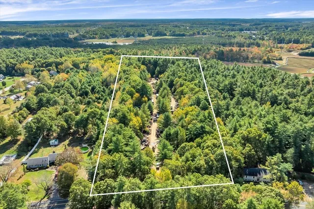 a big yard with lots of green space and white house