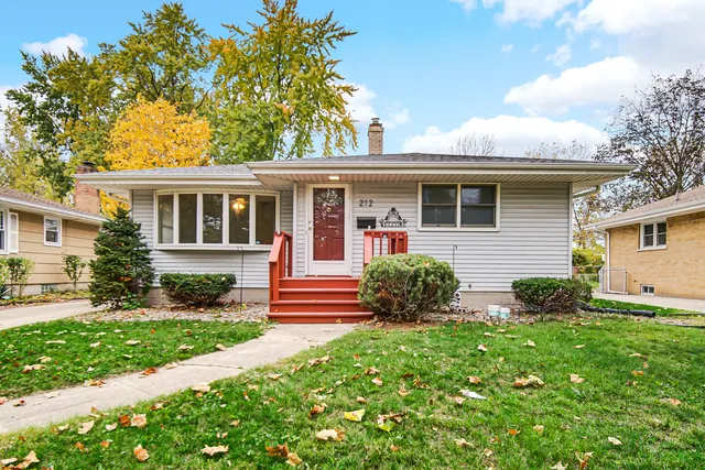 a view of a house with a yard and plants