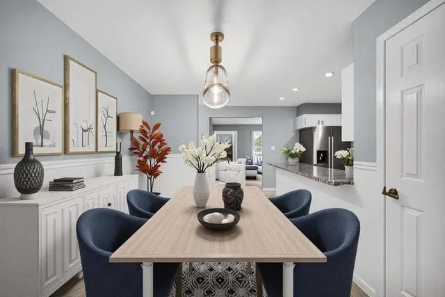 a view of a dining room with furniture and a chandelier