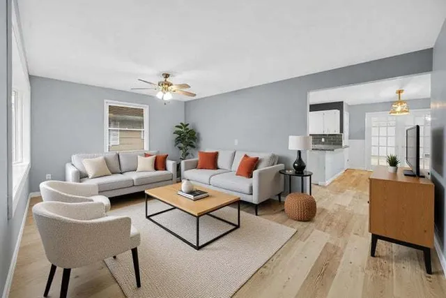 a living room with furniture and a chandelier