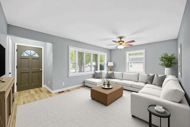 a living room with furniture and a large window