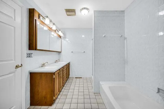 a bathroom with a sink a mirror and a bathtub