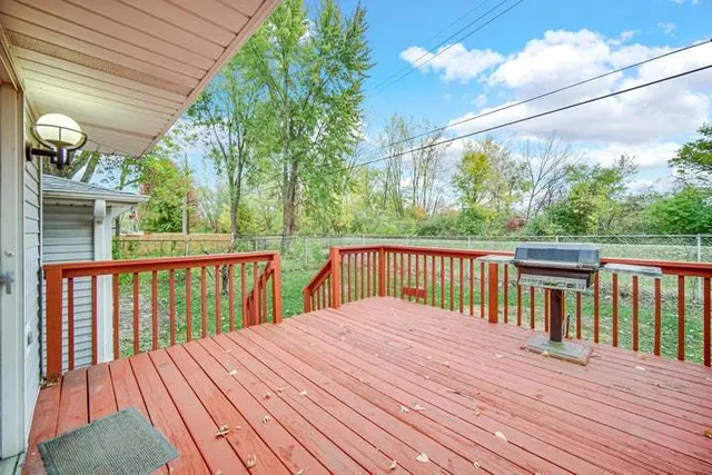 a balcony with wooden floor and fence