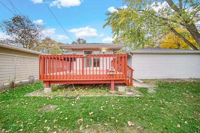 a view of a chair in the backyard of the house