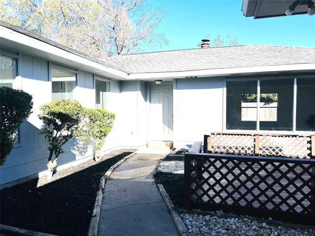 a living room with a fireplace and chandelier